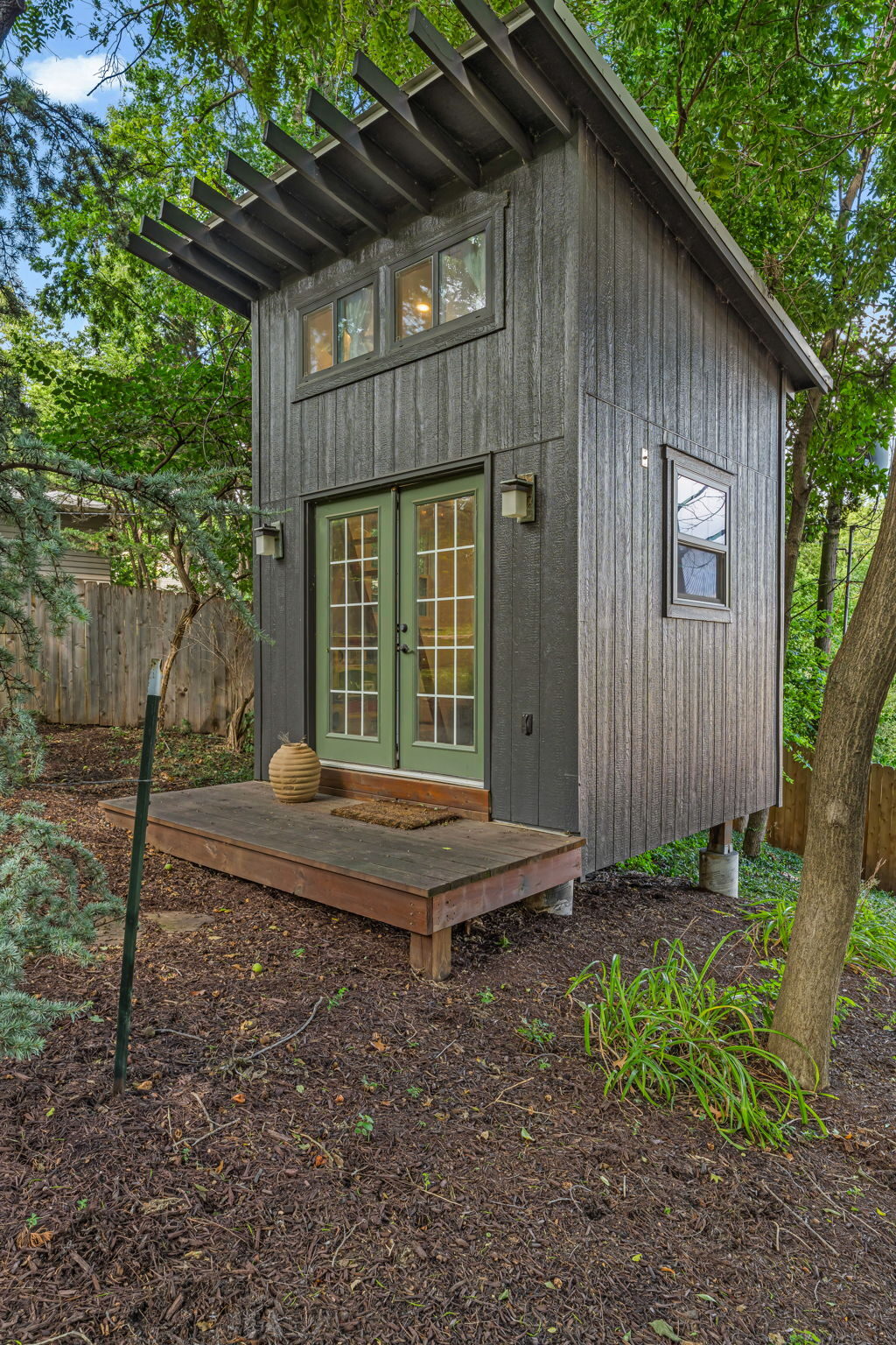 Detached studio building with green French doors