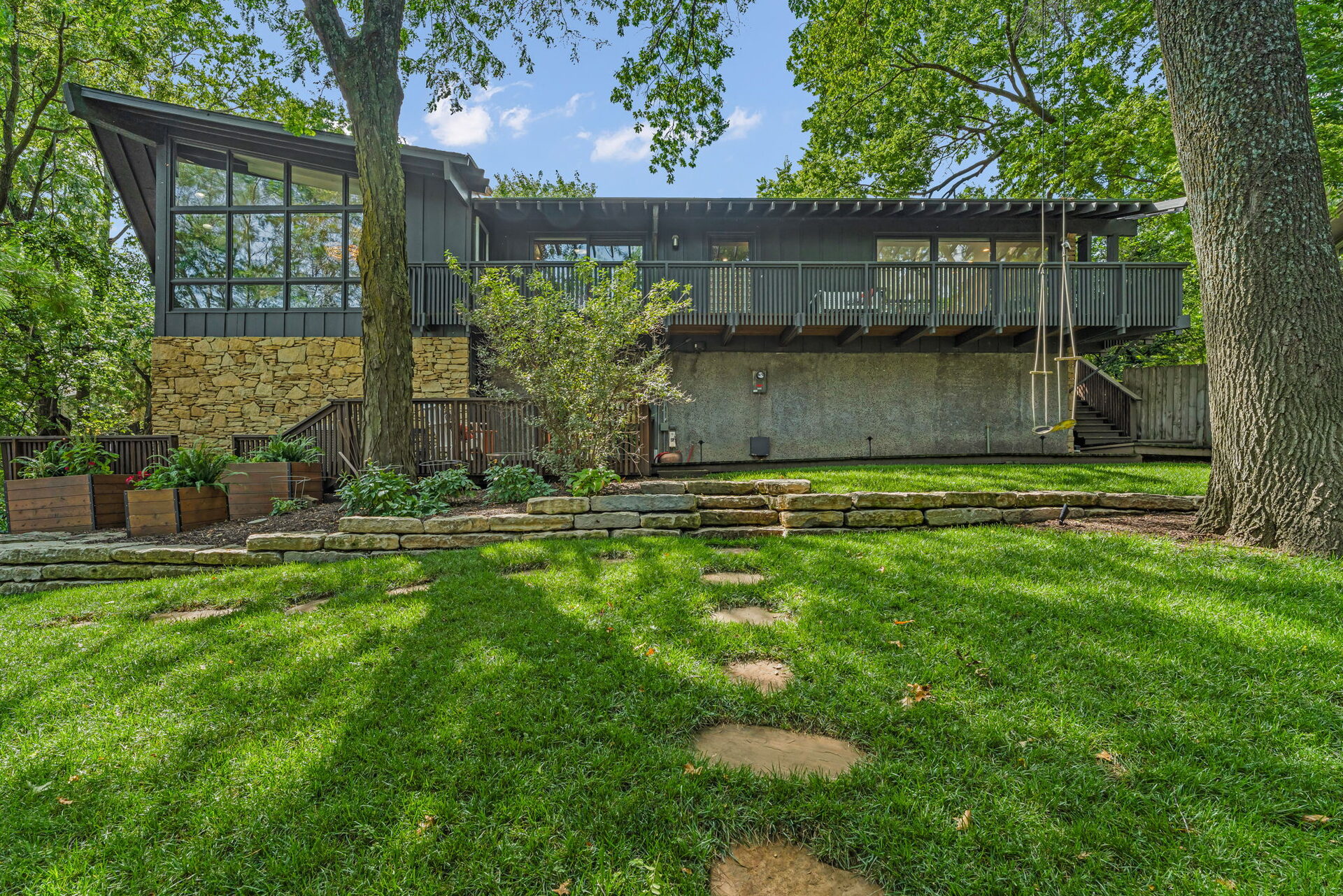 Rear exterior of the home with wraparound deck