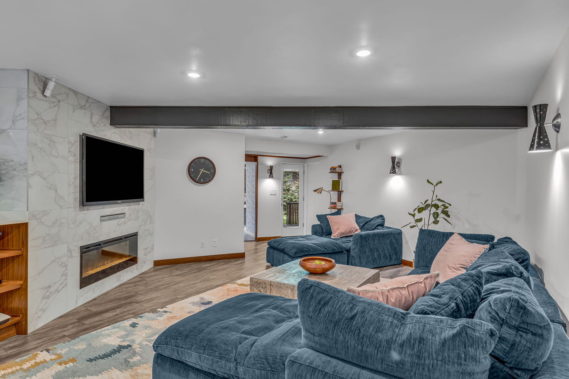 Lower level living area with blue sectional