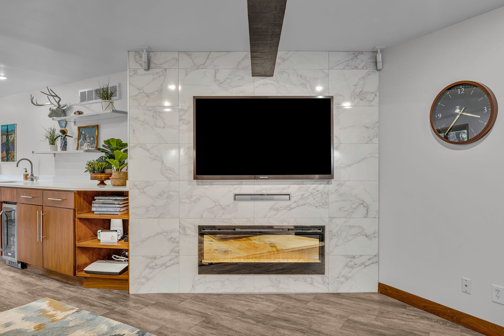 Lower level marble-look fireplace and media wall