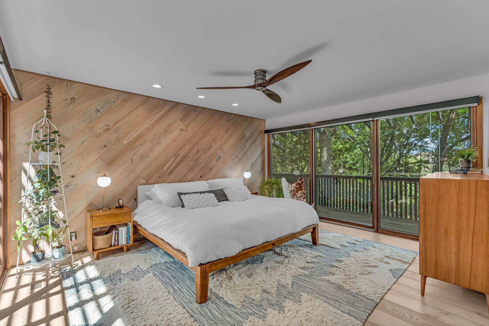 Primary bedroom with diagonal wood accent wall
