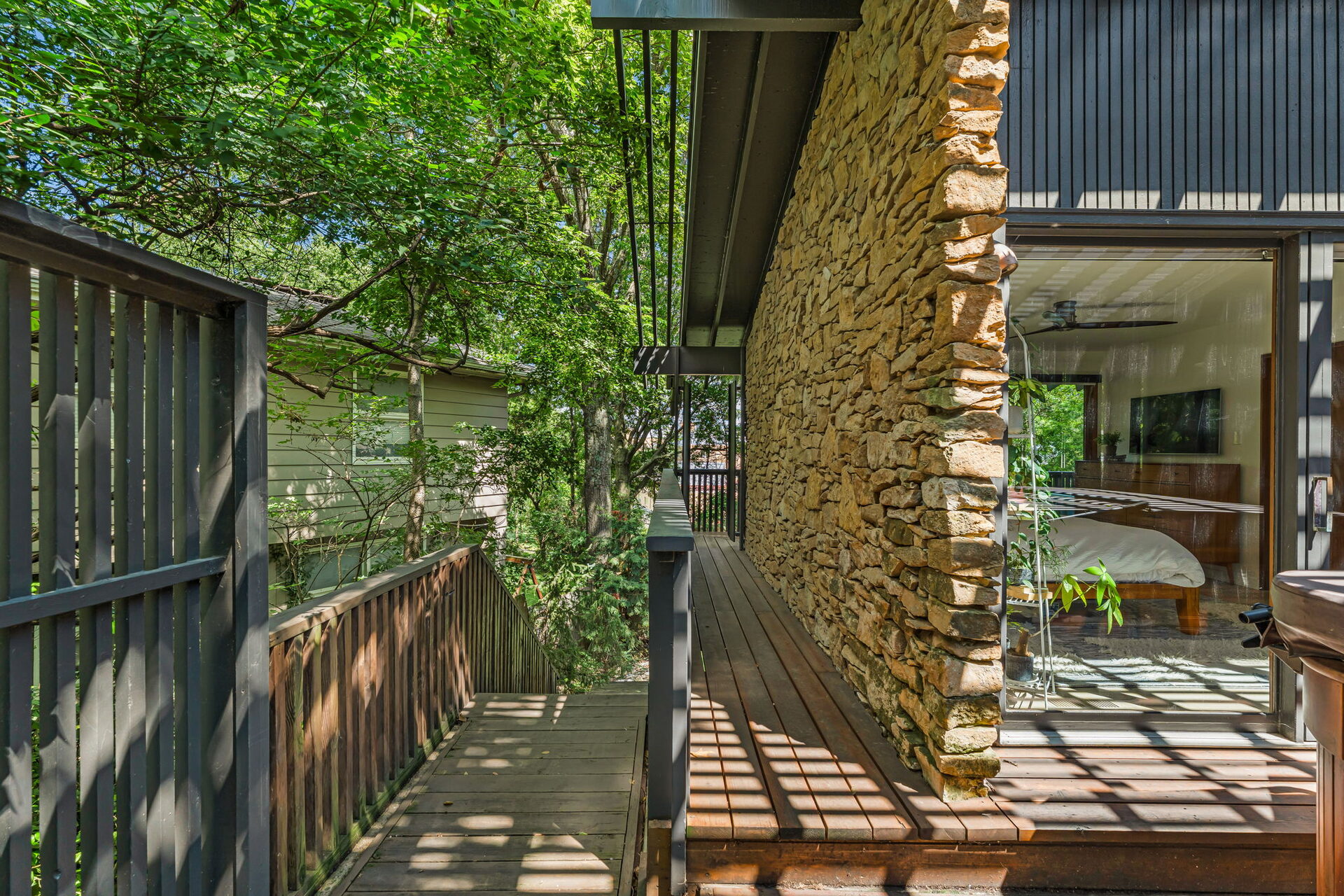 Side deck along the stone wall leading to the primary suite