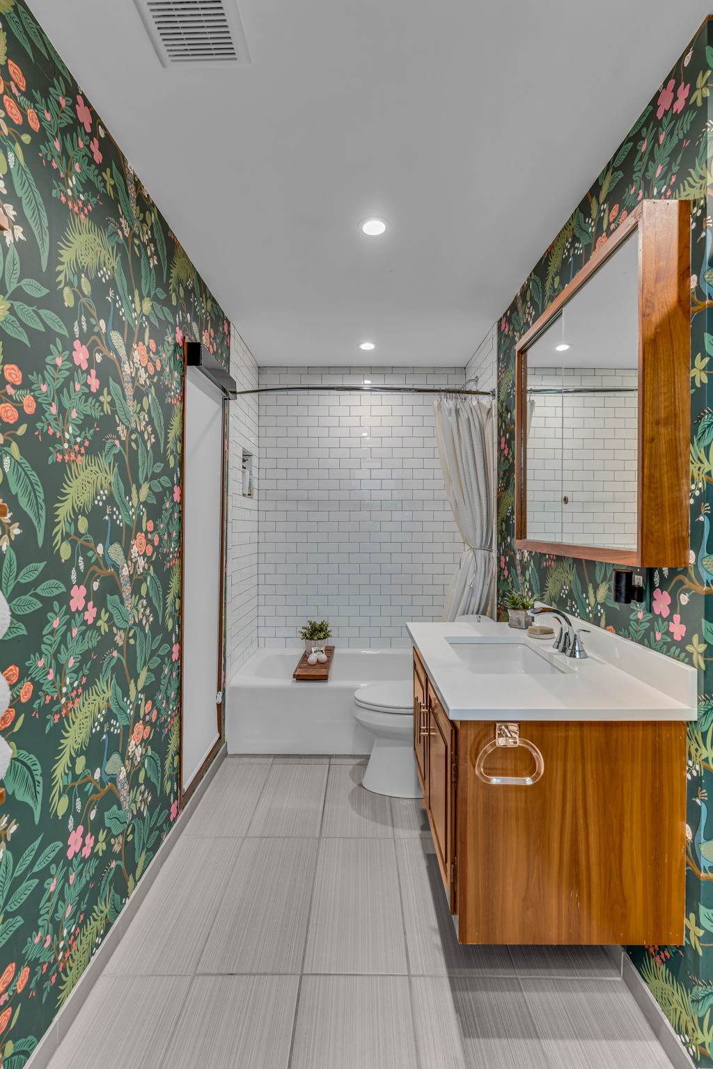 Bathroom with floral wallpaper and subway tile