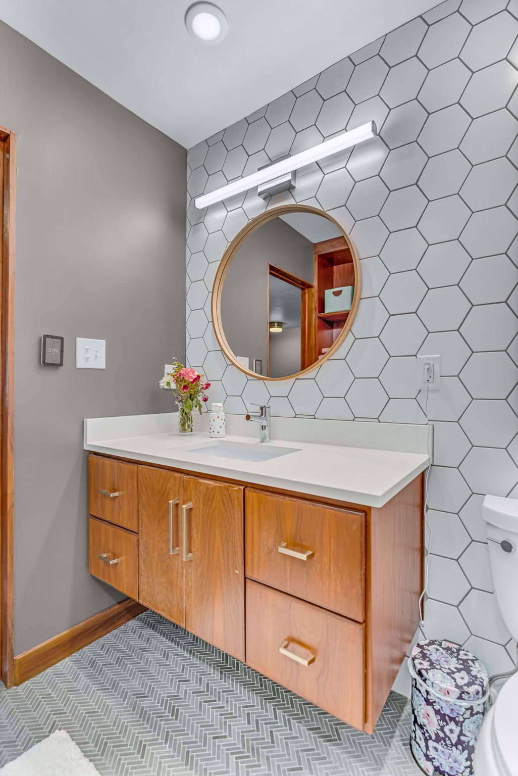Hex tile bathroom with floating walnut vanity